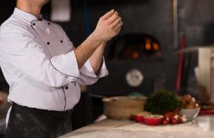 chef throwing up pizza dough photo