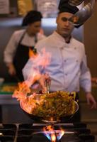 Chef doing flambe on food photo