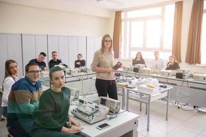 students doing practice in the electronic classroom photo