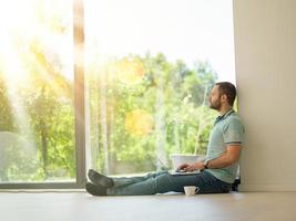 man drinking coffee on the floor enjoying relaxing lifestyle photo