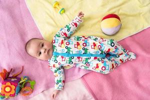 top view of newborn baby boy lying on colorful blankets photo