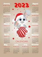 calendario 2023 con símbolo del año liebre (conejo). linda liebre (conejo) sentada con bola de navidad. la semana comienza el lunes. vector