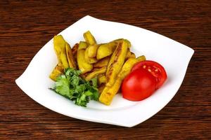 Frid eggplant on the plate and wooden background photo