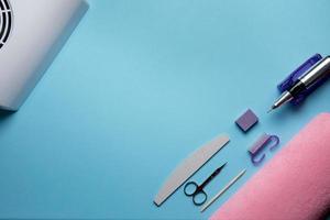 Top view of manicure and pedicure equipment on blue background photo