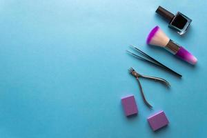 Top view of manicure and pedicure equipment on blue background photo