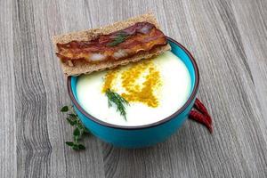 Cheese soup on wood photo