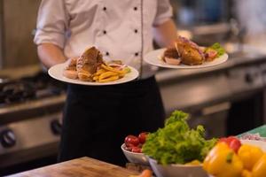 Chef showing dishes of tasty meals photo