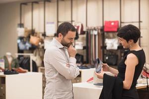 couple chooses shoes At Shoe Store photo