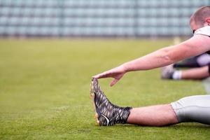 american football players stretching and warming up photo