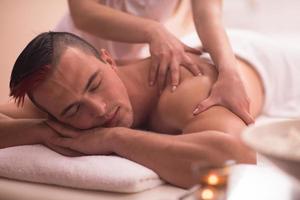 young man having a back massage photo