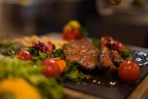 Chef finishing steak meat plate photo