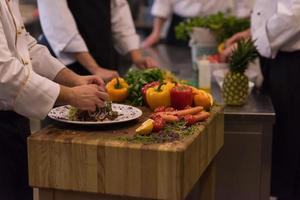 chef serving vegetable salad photo