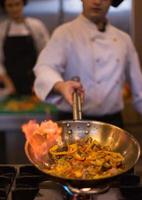 Chef doing flambe on food photo