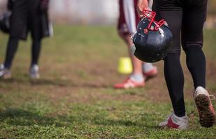 American football player holding helmet photo