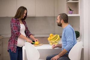 couple cooking food fruit lemon juice at kitchen photo