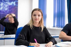 female student writing notes photo