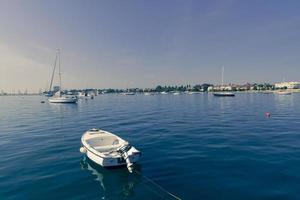 A photograph of a ship and a luxury yacht anchored in port. Beautiful photo of a Mediterranean port