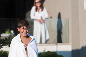 The boy enjoys a summer day swimming in the pool. The concept of a family vacation. Selective focus photo