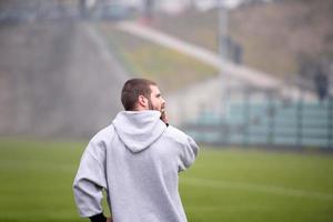 american football player warming up and stretching photo