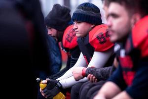 american football player resting with teammates photo