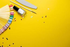 Top view of manicure and pedicure equipment on yellow background photo