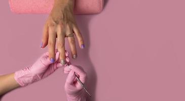 Manicure process on pink background, top view.Manicure in beauty salon.Manicure concept,banner photo