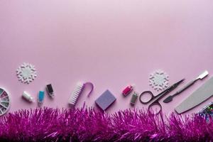 Top view of manicure and pedicure equipment on pink christmas background photo