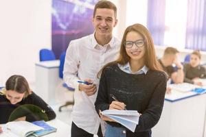 young students writing notes photo