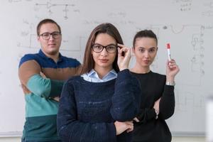 portrait of young students in front of chalkboard photo