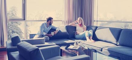 couple relaxing at  home using tablet computer photo