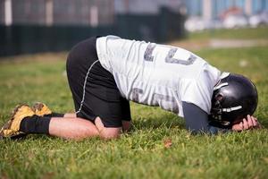american football player resting after hard training photo