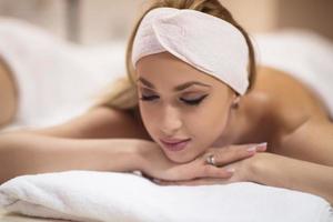 woman laying on massage table photo