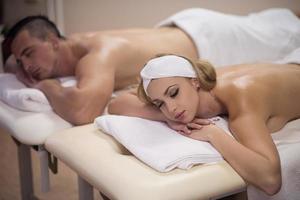 young couple lying on massage table photo