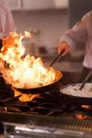 Chef doing flambe on food photo