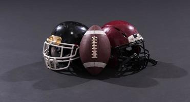 fútbol americano y cascos aislados en gris foto