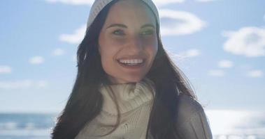 Girl In Autumn Clothes Smiling on beach photo