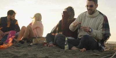 Friends Relaxing At Bonfire Beach Party photo