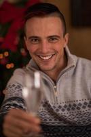 Happy young man with a glass of champagne photo