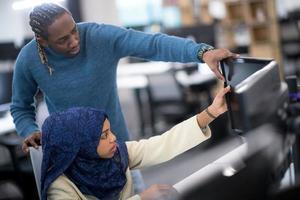 young black muslim female software developer at work photo