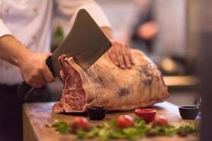 chef cutting big piece of beef photo