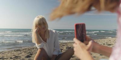 Two girl friends having fun photographing each other on vecation photo