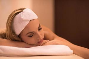 woman laying on massage table photo