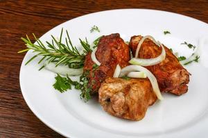 Shashlik on the plate and wooden background photo