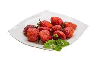 Ripe strawberry on the plate and white background photo