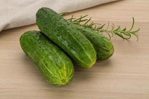 Cucumber on wooden background photo