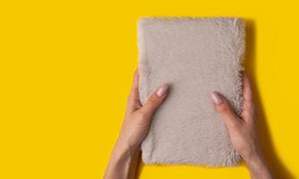 Female hands with a beautiful manicure on a yellow background,top view photo