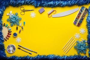 Top view of manicure and pedicure equipment on a yellow christmas background with tinsel photo