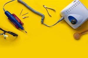 Top view of manicure and pedicure equipment on yellow background photo