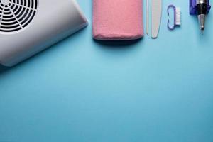 Top view of manicure and pedicure equipment on blue background photo