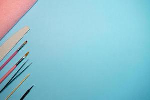 Top view of manicure and pedicure equipment on blue background photo